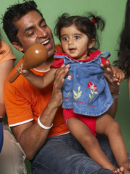 Dad and baby smiling during music class