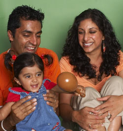 Mom and Dad singing with baby in music class for infants